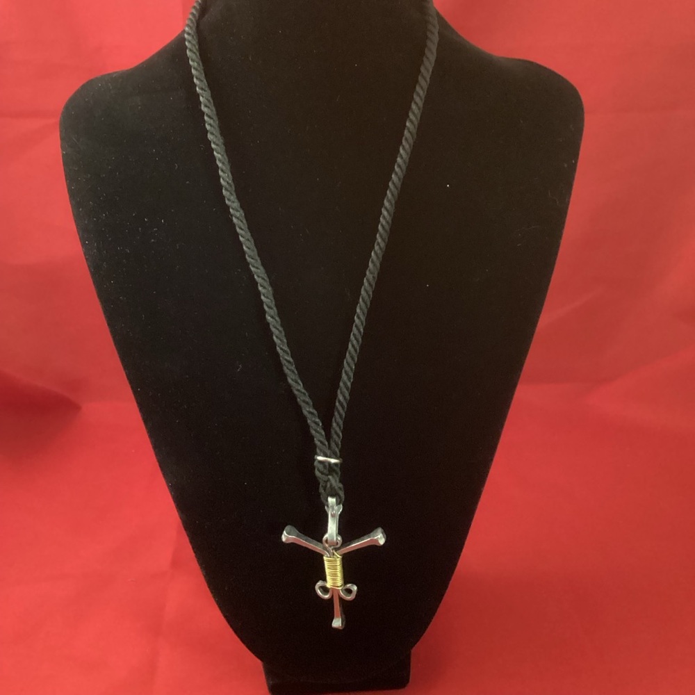 Weird mixed metal pendant on a fabric lace necklace